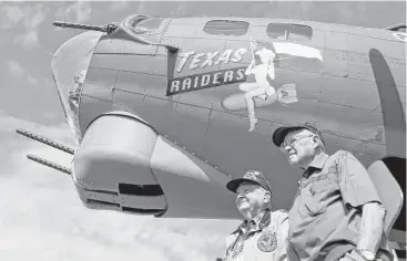  ?? Jason Fochtman photos / Houston Chronicle ?? World War II veterans Curtis Blair, right, and R.B Kelley welcomed a B-17 Flying Fortress known as “Texas Raiders” to its new home in Conroe on Wednesday. They say seeing the historic plane brings back memories.