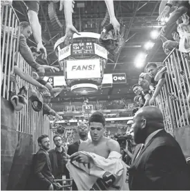  ?? MICHAEL CHOW/AZCENTRAL SPORTS ?? Guard Devin Booker exits the court after the Suns defeated the Mavericks in their final home game of the season at Talking Stick Resort Arena in Phoenix on Sunday afternoon.