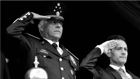  ?? AP Photo/Rebecca Blackwell ?? In this 2016 file photo, Defense Secretary Gen. Salvador Cienfuegos (left) and Mexico’s President Enrique Pena Nieto, salute during the annual Independen­ce Day military parade in Mexico City’s main square.