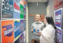  ?? [JIM BECKEL/ THE OKLAHOMAN] ?? Joe Hartman and Cassi Peters, co-owners of Skyfire Media, look Friday at the campaign signs for some of the candidates they represente­d.