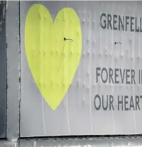  ??  ?? A banner with a green heart on it is now wrapped around the tower block