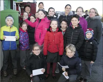  ??  ?? ABOVE: Locals and school children with postmistre­ss Nicola Howlin last Friday. LEFT: The pupils from Danescastl­e National School posting their letters. BELOW: One of the children’s letters.