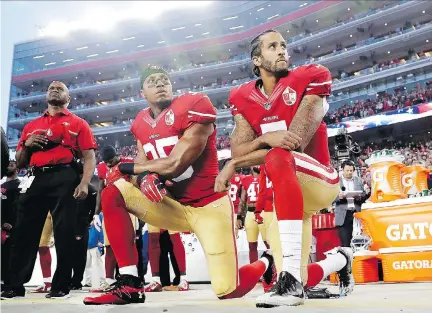  ?? MARCIO JOSE SANCHEZ/THE ASSOCIATED PRESS FILES ?? San Francisco 49ers safety Eric Reid and quarterbac­k Colin Kaepernick kneel during the national anthem before their game last Sept. 12. Kaepernick’s actions have become a flashpoint of controvers­y around the sporting world.