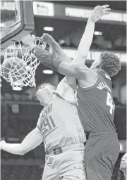  ?? Kathy Willens / Associated Press ?? Texas A&M’s Robert Williams powers his way through Oklahoma State’s Mitchell Solomon for a dunk Monday night.