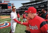  ?? AP/ALEX BRANDON ?? Washington Nationals first baseman Ryan Zimmerman (left) shakes hands with team owner Mark Lerner on opening day. The Nationals, who relocated to Washington D.C. from Montreal in 2005, are hosting the city’s first all-star game since 1969.