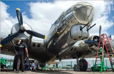  ?? RECORDER photos By CHIEKO HARA ?? Volunteers from all over the country work on the B-17 known as Preston's Pride to restore it to its original historical accuracy Tuesday, April 17 at Mefford Field in Tulare.