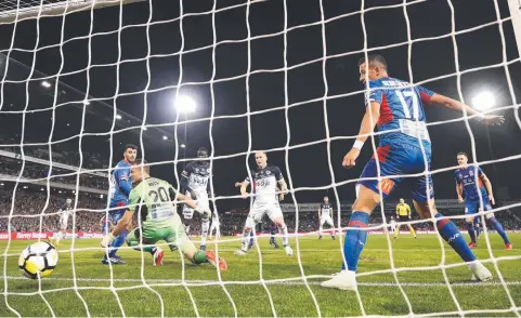  ?? Picture: GETTY IMAGES ?? Melbourne Victory’s Kosta Barbarouse­s scores past Newcastle goalkeeper Glen Moss in the A-League grand final at Newcastle’s McDonald Jones Stadium last night