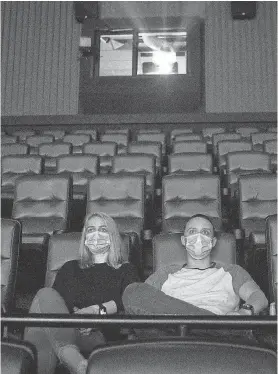  ?? JAY JANNER/ AUSTIN AMERICAN- STATESMAN ?? Kayleigh Tansey and Justin Smith take in a movie on May 4 at EVO Entertainm­ent in Kyle, Texas.