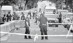  ?? AP/SETH WENIG ?? Numbers mark the crime scene of the fatal shooting of a police officer Wednesday in the Bronx section of New York. Police shot and killed the assailant about a block away.