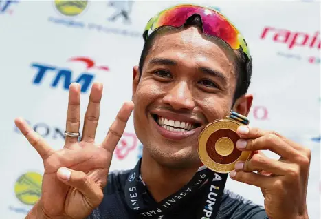  ??  ?? Mohd Najib Turano is all smiles after winning his fourth gold in the track and road events. These are four you Malaysia: