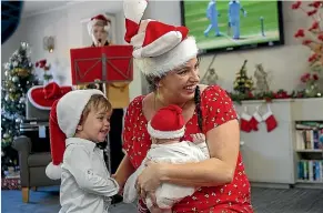  ?? WARWICK SMITH/STUFF ?? Mason Jones, right, mother Carla and sister Mia at the adopt a senior Christmas party.