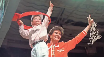  ?? AP FILE PHOTO BY PAT SULLIVAN; SUMMITT FAMILY PHOTO ?? Coach Pat Summitt and son Tyler take down the net after Tennessee won the NCAA women’s basketball title in March 1996. At right, Summitt, 2-year-old son Breck and wife Brooklyn.