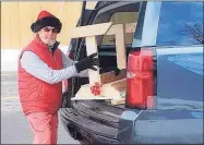  ?? Contribute­d photo / Joanne Jukins ?? Middletown architect Steve Nelsen unloads his handmade desks to Macdonough Elementary School on Spring Street.