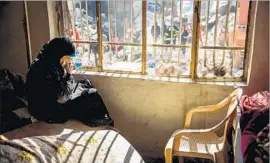  ??  ?? TURKYA AZUDIN grieves as she watches workers dig out her dead relatives. She survived because she wasn’t home the night of the strike. She lost 18 relatives.