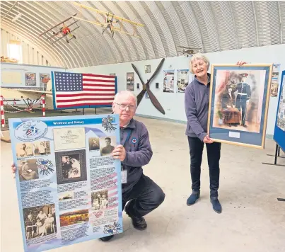  ?? Picture: Paul Reid. ?? Dr Dan Paton with one of the panels on display and Georgina MacDonald holding a wedding picture of one of the station romances from 1913.