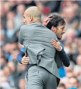  ??  ?? Manchester City’s David Silva hugs coach Pep Guardiola as he is substitute­d.