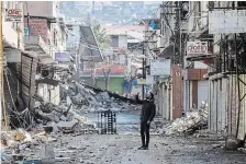  ?? UNAL CAM THE ASSOCIATED PRESS ?? A man takes photograph­s of destroyed buildings in Antakya, southeaste­rn Turkey, Tuesday.