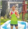  ?? TIM MORIN — CONTRIBUTE­D ?? Erin Morin cools off in her backyard in Massachuse­tts, after winning the Noyo Headlands 5K and 10K races.