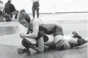  ?? ANDREW ULOZA FOR THE MIAMI HERALD ?? Stoneman Douglas’ undefeated Gabriela Caro and Nova’s Nayara Stubna battle Saturday during the 130-pound BCAA Wrestling Championsh­ips at Pompano Beach High School.