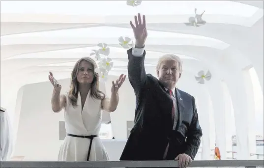  ?? Andrew Harnik The Associated Press ?? President Donald Trump and first lady Melania Trump throw flower petals while visiting the Pearl Harbor Memorial on Friday in Honolulu. The president set out on a 12-day, five-country trip in Asia, with Japan as his first stop.