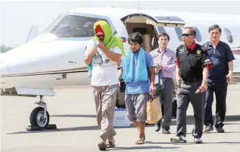  ?? — AFP ?? Captain Chul Hong Park (L), a South Korean national, and 2nd officer Filipino Glenn Alindajao (2 L), two hostages released in Jolo Sulu, arrive in Davao City with Philippine Peace Adviser Secretary Jesus Dureza (2nd R) on Saturday.