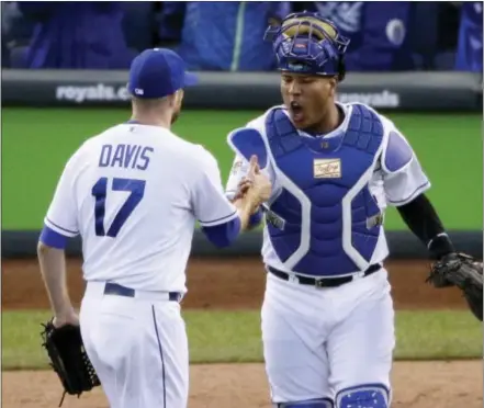  ?? JAE C. HONG — THE ASSOCIATED PRESS ?? Kansas City Royals catcher Salvador Perez, right, and relief pitcher Wade Davis celebrate their 6-3 win against the Toronto Blue Jays in Game 2 of the American League Championsh­ip Series on Saturday.