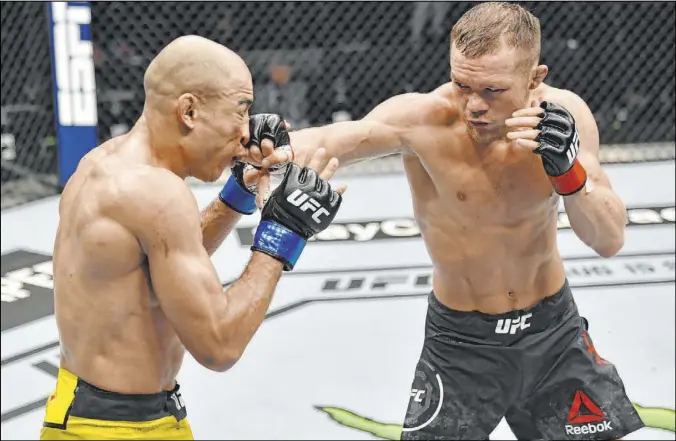  ?? Jeff Bottari Zuffa LLC ?? Russian bantamweig­ht Petr Yan lands a right to the nose of Jose Aldo in their UFC 251 title fight Sunday on “Fight Island” in Abu Dhabi, United Arab Emirates.