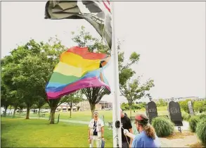  ?? Brian A. Pounds / Hearst Connecticu­t Media ?? Tomer Harel, left, of Shelton, and Mayor Mark Lauretti raise a Pride flag.