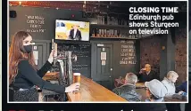  ??  ?? CLOSING TIME Edinburgh pub shows Sturgeon on television