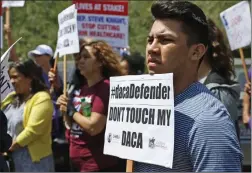  ?? Katharine Lotze/The Signal ?? Supporters of Deferred Action for Childhood Arrivals (DACA) rally outside Representa­tive Steve Knight’s Santa Clarita offices on August 15.