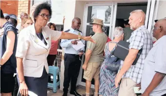  ??  ?? CIVIC supervisor at the Scottburgh Home Affairs office, Nosipho Mkhuphela, 52, is the latest viral star – after a Facebook post was shared more than 11 000 times, thanking her for her service, after she assisted a group of people past her working hours. Mkhuphela regularly goes outside to check how long the lines are and to greet people.