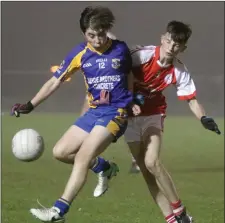  ??  ?? An airborne Fionn Mullally of Clúain O’Rahilly’s wins this duel with Eoin Doran (Monageer-Boolavogue).