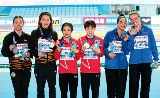 ??  ?? Lu Wei y Zhang Jiaqi ( al centro) ganan la medalla de oro en la prueba de plataforma de 10 metros.