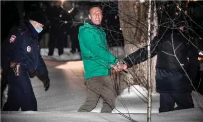  ??  ?? Alexei Navalny being escorted out of a police station in Khimki, outside Moscow, after the court ruling that ordered him jailed for 30 days. Photograph: Alexander Nemenov/AFP/Getty Images