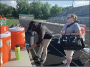  ?? JOHN KAMPF - THE NEWS-HERALD ?? Cleveland Clinic Sports Medicine is providing athletic training services all week for The News-Herald Senior Bowl. Above, athletic trainers, Tarryn Hardgrove and Patty Gehring prepare for Day 1of practice at Mayfield Wildcat Stadium.