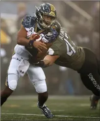  ?? ADAM HUNGER — THE ASSOCIATED PRESS ?? Navy quarterbac­k Xavier Arline, left, is tackled by Army linebacker Jon Rhattigan in the 121st meeting between the teams Saturday.