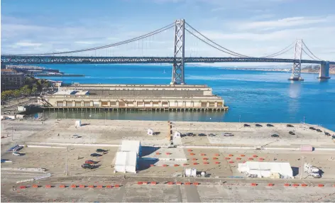  ?? Noah Berger / Special to The Chronicle ?? A coronaviru­s testing site is set up at Pier 30 in San Francisco. The city has responded aggressive­ly to the pandemic from the outset.