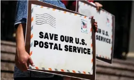  ?? Photograph: Étienne Laurent/EPA ?? People hold signs reading ‘Save our US Postal Service’ in Pasadena, California, in August 2020.