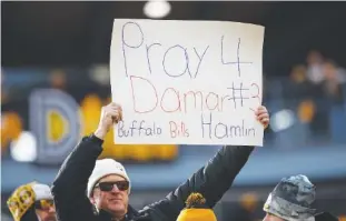  ?? AP PHOTO/MATT DURISKO ?? A fan holds a sign Jan. 8 for Buffalo Bills safety Damar Hamlin, who collapsed on the field during an NFL football game, in Pittsburgh, Pa.