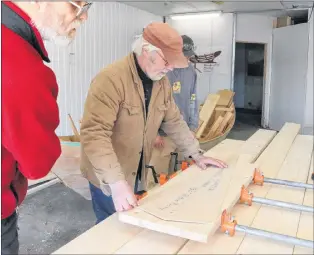  ?? GLEN WHIFFEN/THE TELEGRAM ?? Master boat builder Jerome Canning uses a template to outline where the cuts will be made on planks that are planed, and joined by epoxy and joiner biscuits.