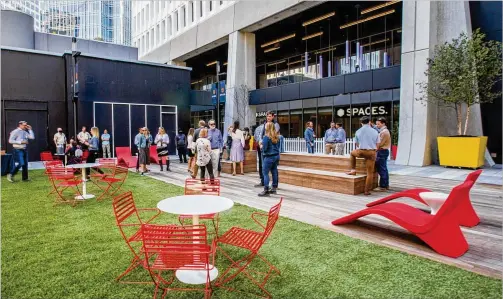  ?? JENNI GIRTMAN FOR THE AJC ?? Midtown’s Colony Square at the corner of Peachtree and 14th streets opened newly renovated space to the public that is open-air with green space and additional loft office space, a trend that managers hope will help workers returning to the office after working at home during the pandemic.