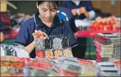  ?? Nhac Nguyen AFP/Getty Images ?? A WORKER makes holiday cards in Hung Yen. Manufactur­ers’ raw materials mostly have to be imported.