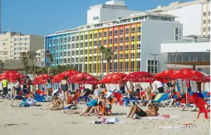  ?? (Marc Israel Sellem/The Jerusalem Post) ?? TEL AVIV BEACHFRONT. UV-rays from sun exposure are believed to be the leading cause of the deadly skin cancer.