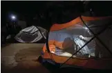  ??  ?? Myanmar climber Pyae Phyo Aung (right) setting up a tent during rock climbing training in Bayin Nyi cave at Hpa-an, Karen state.