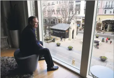  ?? PHOTOS BY JIM GENSHEIMER — STAFF PHOTOGRAPH­ER ?? From a Santana Heights residents lounge, John French looks over the open square and shops at Santana Row in San Jose. French has lived for five years in an apartment at Santana Heights, within Santana Row.