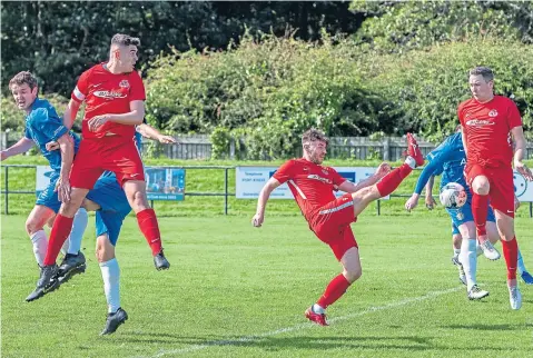  ??  ?? Action from last week’s game between Carnoustie (red) and Lochee United at Laing Park. The Bluebells won 4-2.