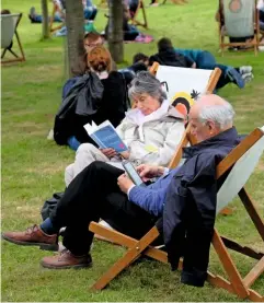  ??  ?? Visitors to the annual Hay Festival enjoy a chance to read and relax. The event was begun in 1988.