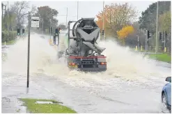  ??  ?? Wet weather and flooding. Desford Road, outside the Next HQ at Enderby.