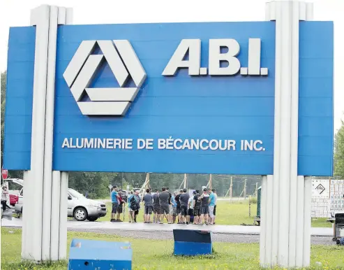  ?? CHRISTINNE MUSCHI / BLOOMBERG ?? Locked-out workers gather outside the ABI aluminum plant in Becancour, Que., last month. For Alcoa, the dispute has resulted in a production decline at the plant, adding to pressures resulting from U.S. aluminum tariffs.