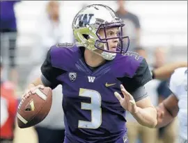  ?? Elaine Thompson Associated Press ?? WASHINGTON QUARTERBAC­K Jake Browning, a freshman, has completed 65% of his passes, with five touchdowns and four intercepti­ons.